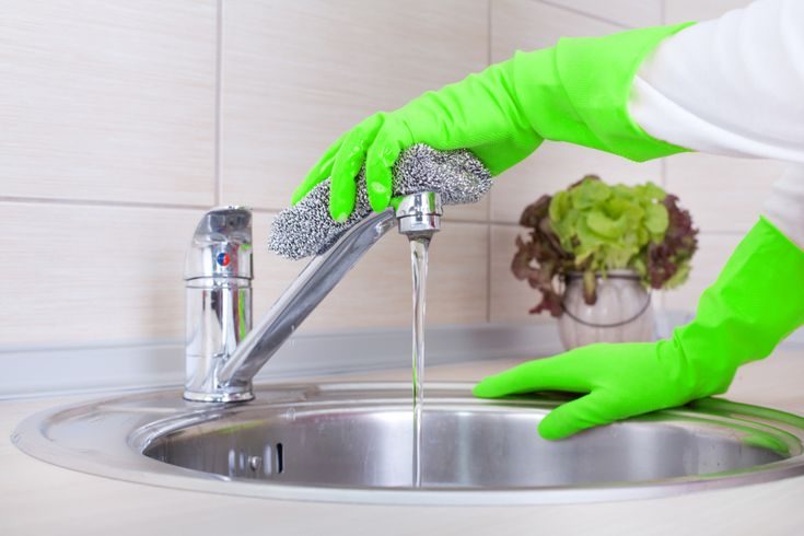 woman-cleaning-kitchen-faucet